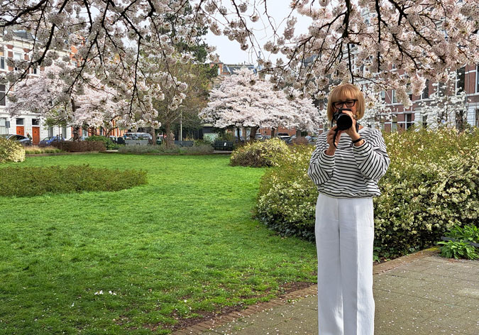 Blue and white striped sweater with white trousers