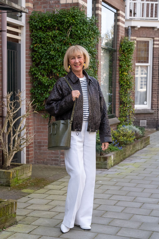 Brown braided leather jacket with white trousers