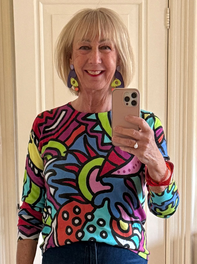 colourful jumper with multicoloured earrings