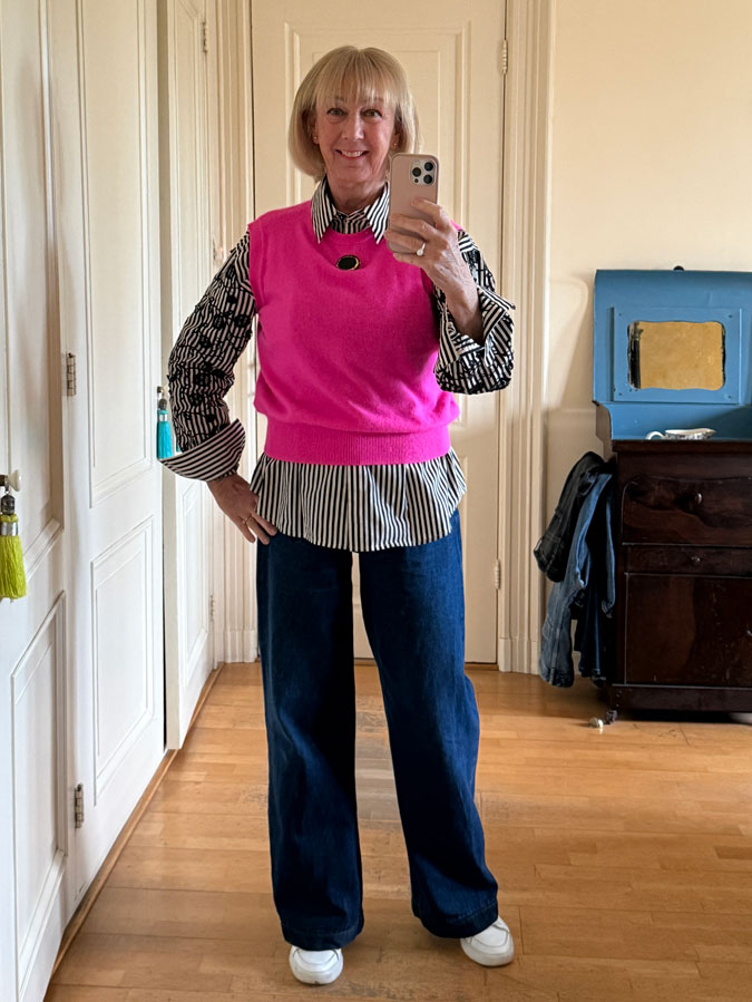 Bright pink vest with black and white shirt