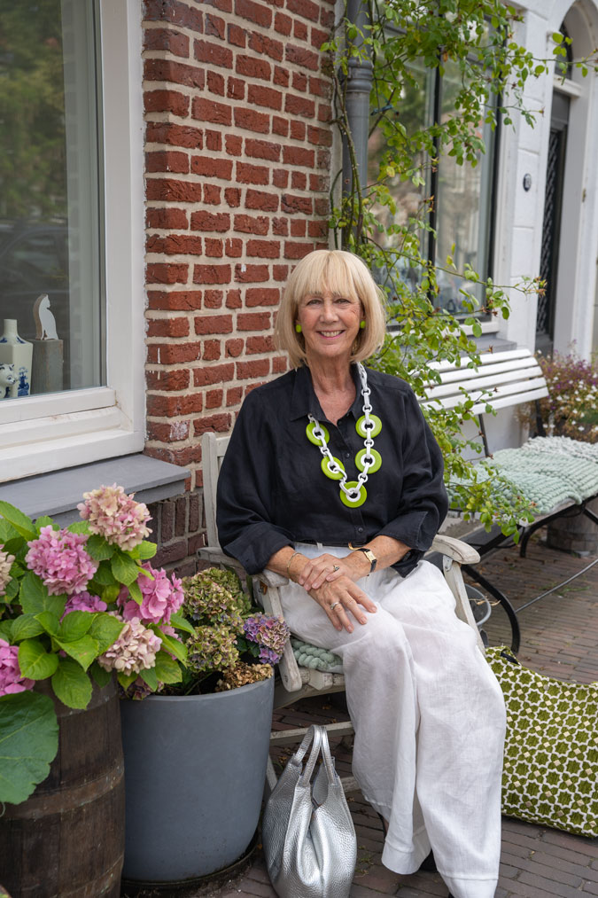 White linen trousers and green Angela Caputi necklace