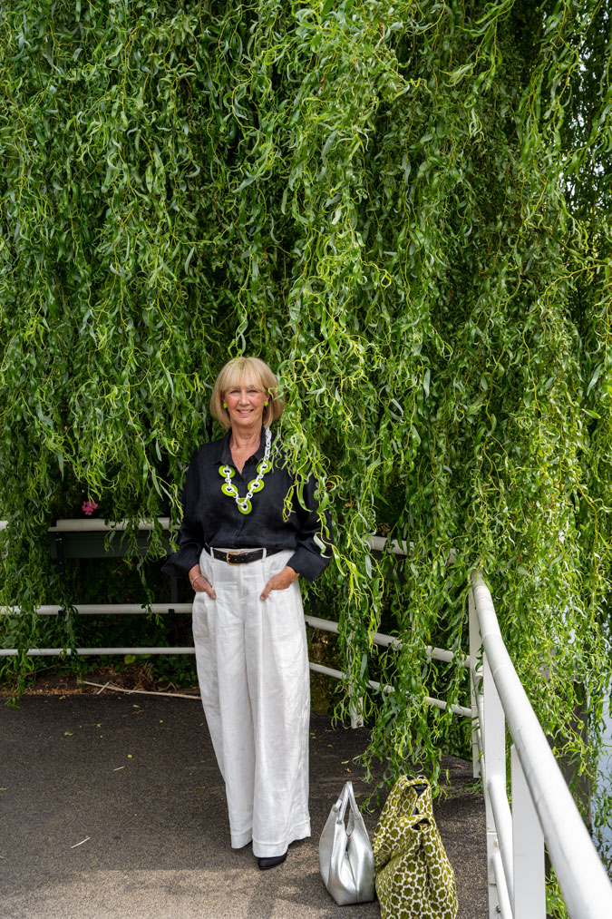 White linen trousers and green Angela Caputi necklace