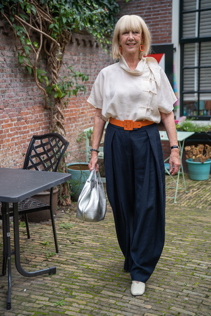 Wide blue trousers with a cream top