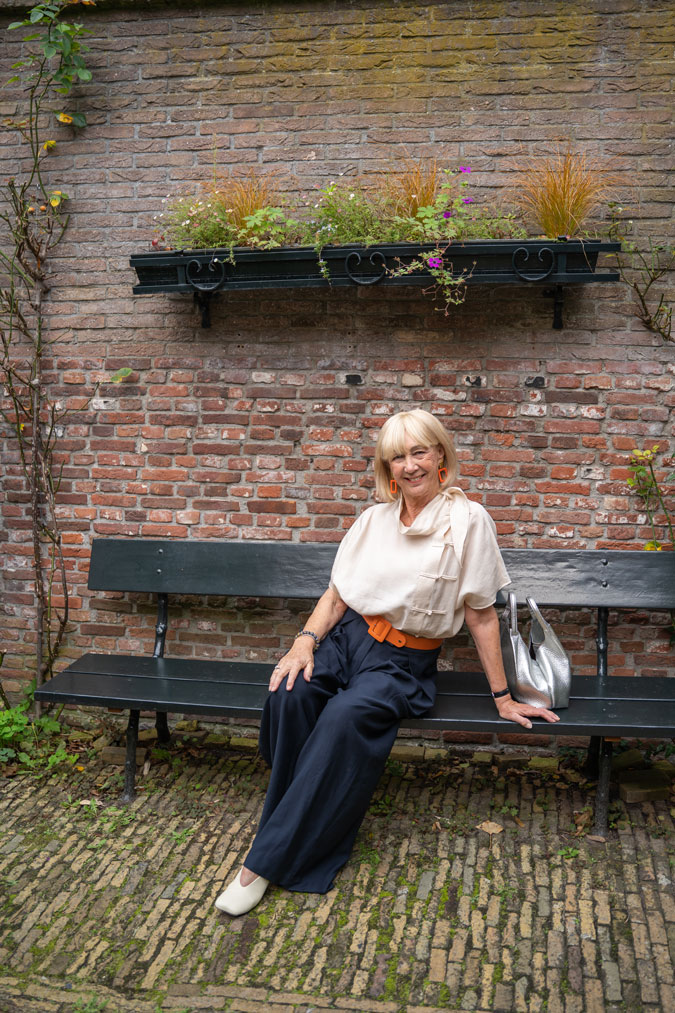 Wide blue trousers with a cream top