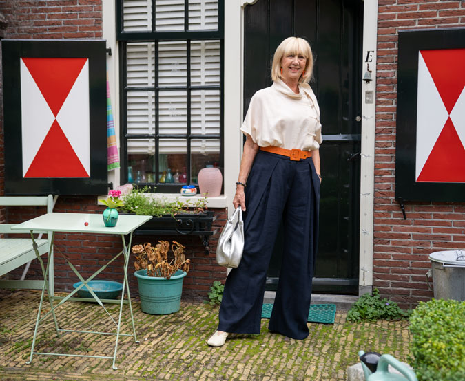 Wide blue trousers with a cream top