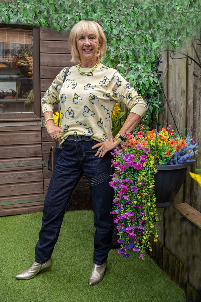 Pale yellow jumper with dark blue jeans